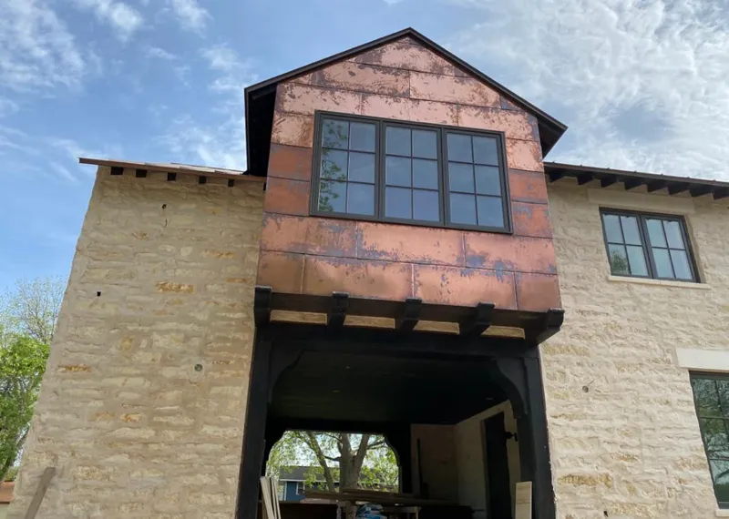 Copper metal panel facade on a stone building for Skylight Installation in Farragut